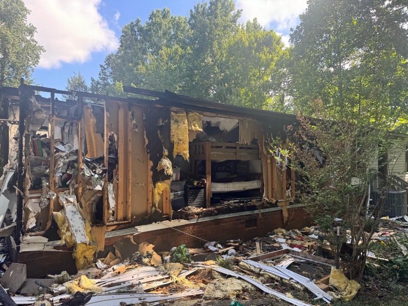 Burnt-out rear elevation of a fire-damaged house before demolition